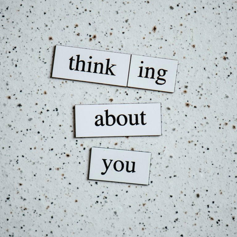 Simple textured background with words 'thinking about you' for creative projects or designs.